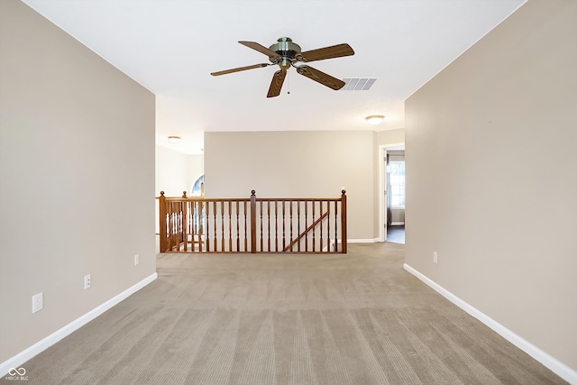 empty room with light colored carpet and ceiling fan