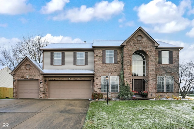 view of front of property featuring a garage and a front lawn