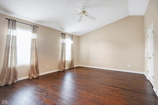 empty room featuring dark hardwood / wood-style floors, ceiling fan, and vaulted ceiling