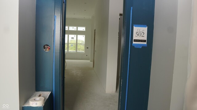 hall featuring concrete flooring