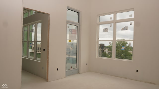 doorway to outside featuring carpet flooring