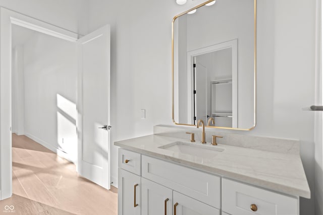 bathroom with vanity and wood finished floors