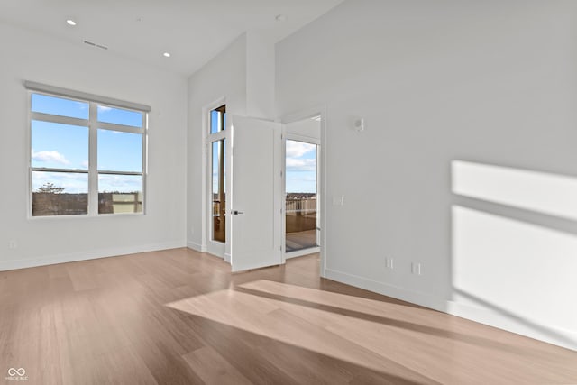 spare room with visible vents, recessed lighting, baseboards, and wood finished floors