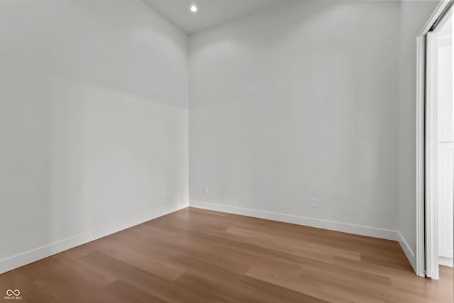 empty room featuring recessed lighting, light wood-style floors, and baseboards