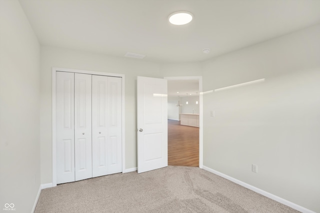 unfurnished bedroom with a closet and carpet