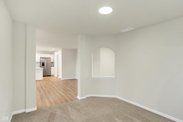 unfurnished room with light colored carpet