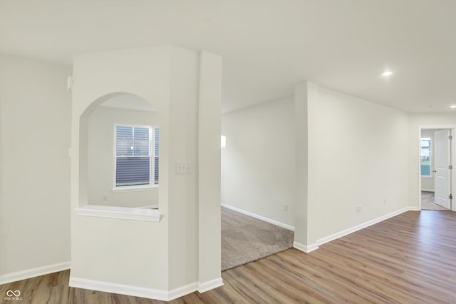 spare room with light hardwood / wood-style floors and plenty of natural light