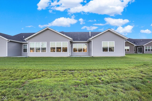 back of house featuring a lawn