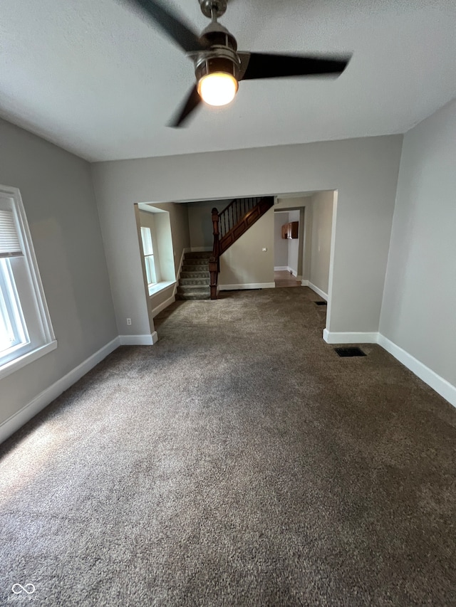 interior space with ceiling fan