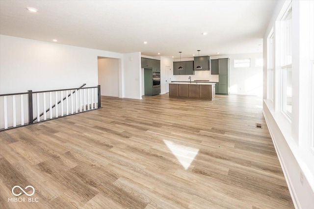 unfurnished living room featuring wood-type flooring