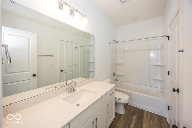 full bathroom featuring toilet, vanity,  shower combination, and hardwood / wood-style flooring