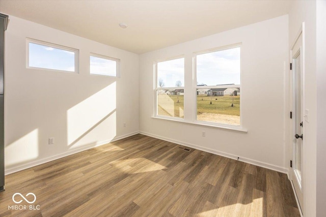 spare room featuring hardwood / wood-style floors