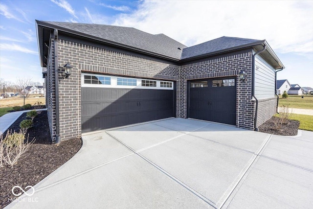 garage featuring concrete driveway