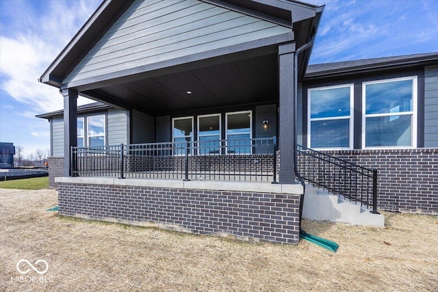 rear view of property featuring a porch