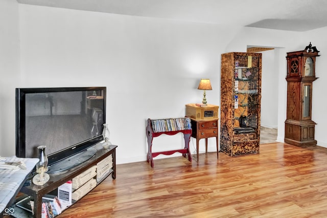 sitting room with baseboards and wood finished floors