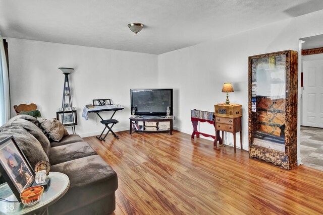 living room with baseboards and light wood-style flooring
