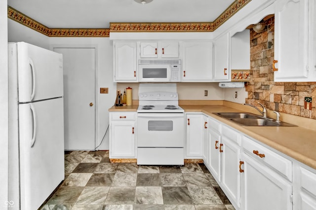 kitchen featuring sink, white cabinets, and white appliances