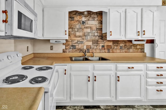 kitchen with white cabinets, backsplash, white appliances, and sink