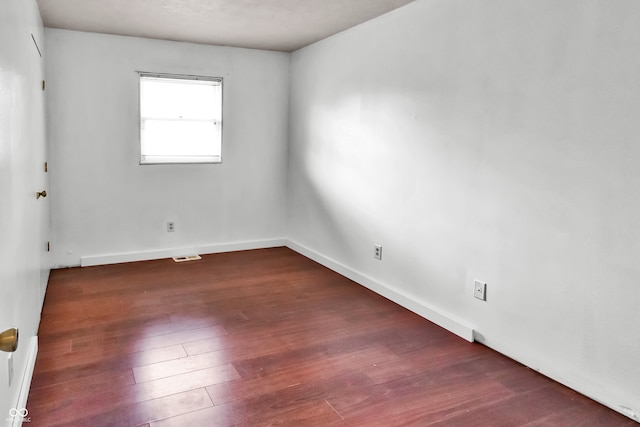 unfurnished room featuring dark hardwood / wood-style flooring