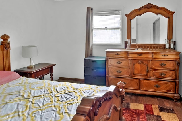 bedroom with dark wood-type flooring