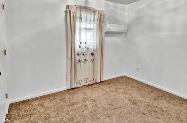 unfurnished room featuring carpet flooring and a wall mounted AC