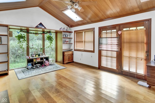 living area featuring wood finished floors, a healthy amount of sunlight, and ceiling fan