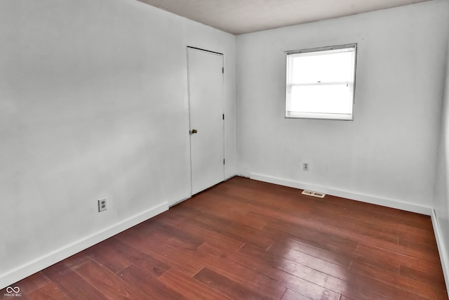 empty room featuring dark hardwood / wood-style flooring