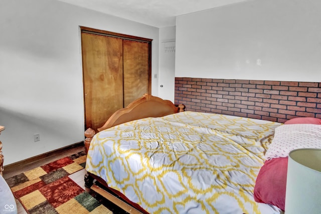 bedroom featuring wood finished floors and a closet