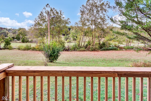 wooden deck featuring a yard