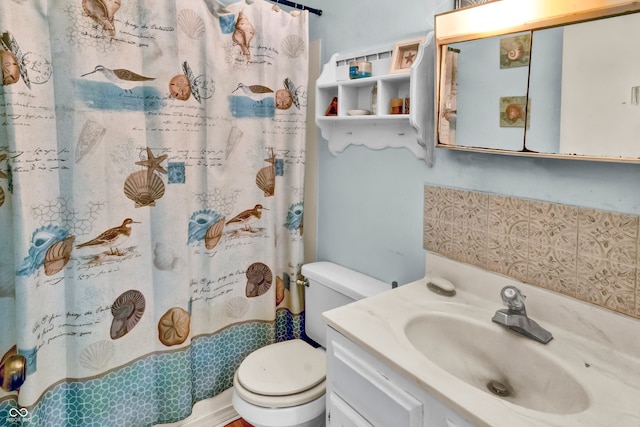 bathroom with vanity, toilet, and walk in shower