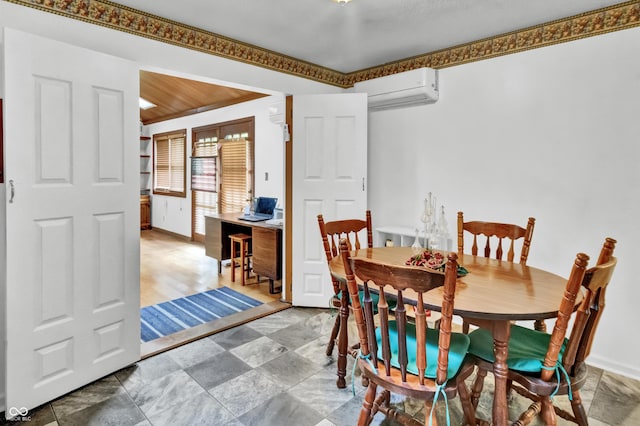 dining room featuring baseboards and a wall unit AC