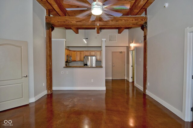 unfurnished living room featuring ceiling fan, beamed ceiling, wooden ceiling, and concrete floors