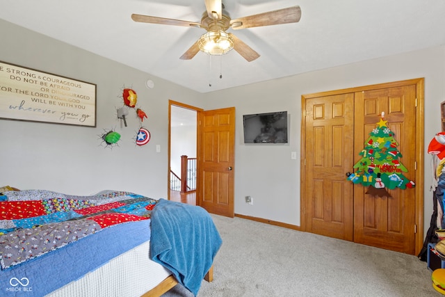 bedroom featuring ceiling fan, a closet, and carpet floors