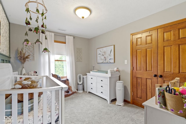 bedroom with light carpet and a nursery area