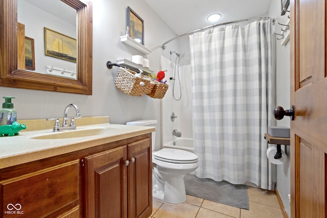 full bathroom featuring toilet, vanity, tile patterned floors, and shower / bath combo with shower curtain