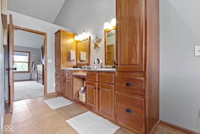 bathroom featuring vaulted ceiling, tile patterned floors, and vanity