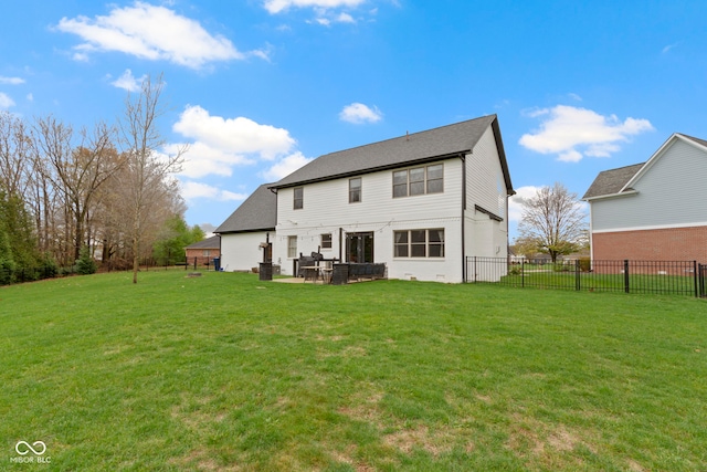 rear view of house with a yard