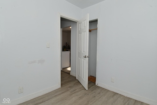 unfurnished room with light wood-type flooring