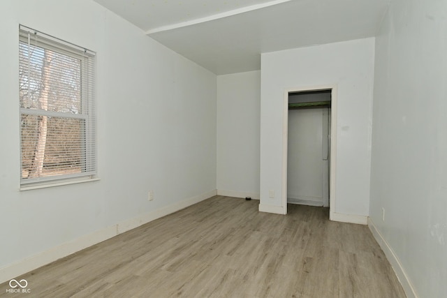 unfurnished bedroom featuring a closet and light hardwood / wood-style flooring