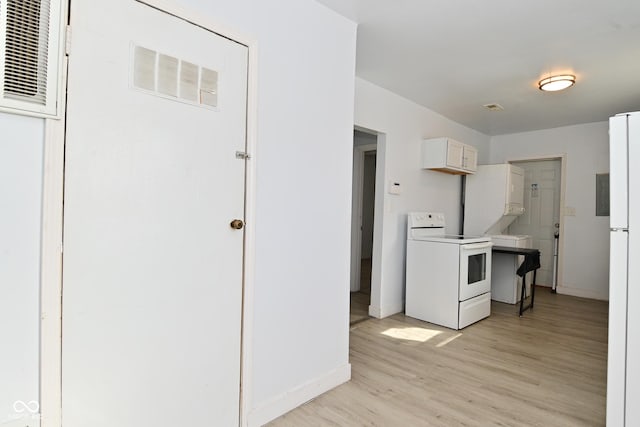 kitchen featuring white cabinetry, white appliances, and light hardwood / wood-style floors