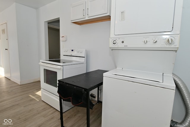 kitchen with white cabinetry, light hardwood / wood-style flooring, white electric stove, and stacked washer and clothes dryer