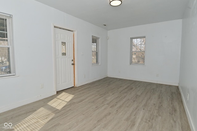 spare room with light hardwood / wood-style flooring