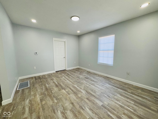 spare room featuring light hardwood / wood-style floors