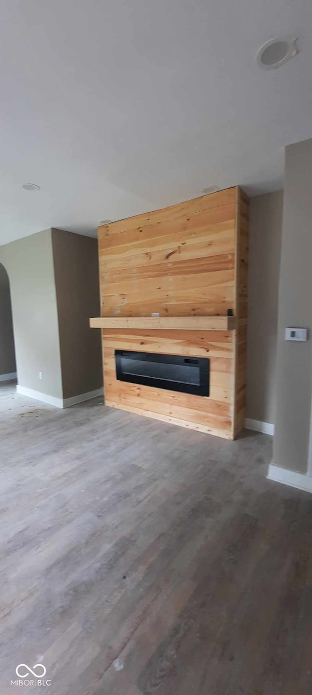 unfurnished living room featuring wood-type flooring