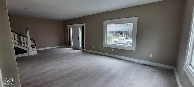 unfurnished living room with hardwood / wood-style floors