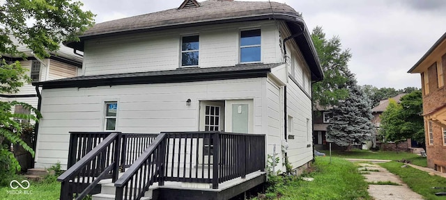 rear view of property featuring a deck