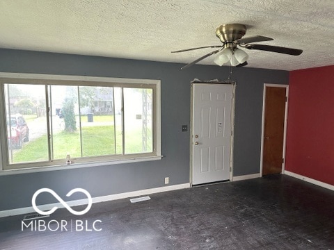 entryway featuring a textured ceiling and ceiling fan