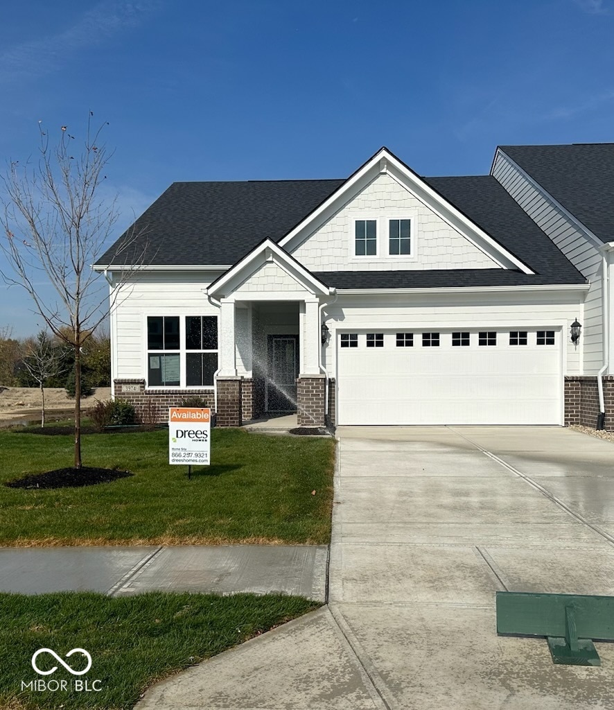 craftsman-style house with a front yard and a garage