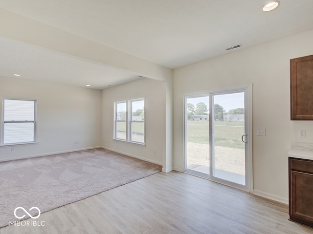 unfurnished living room with light hardwood / wood-style floors