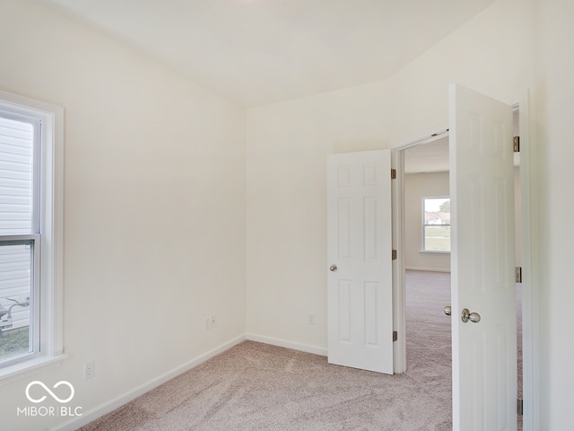 unfurnished room with light carpet